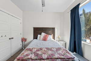 Carpeted bedroom featuring a closet and ceiling fan