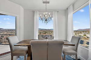Dining area featuring a mountain view, a chandelier, and wood finished floors