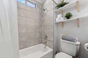 Bathroom featuring toilet and  shower combination