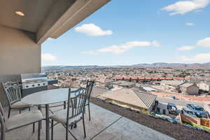 View of patio / terrace with outdoor dining space, a residential view, a grill, and a mountain view