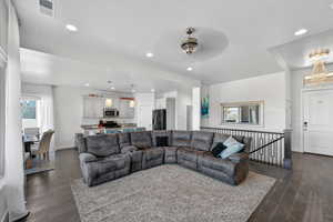 Living room with recessed lighting, dark wood-style flooring, ceiling fan, a textured ceiling, and a chandelier