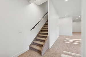 Stairway with recessed lighting and carpet