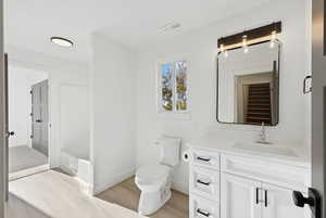 Bathroom featuring vanity and light wood-style floors