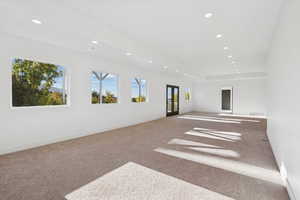 Empty room with french doors, carpet flooring, and recessed lighting