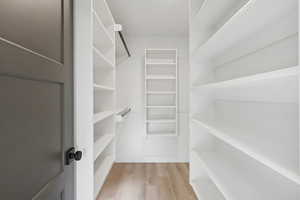 Spacious closet with light wood-style flooring