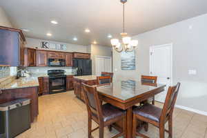 Dining area with a chandelier, recessed lighting, and light tile patterned flooring