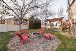 Fenced backyard with a patio area, stairway, and area for grilling