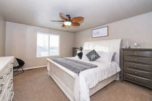 Bedroom featuring light colored carpet and ceiling fan