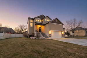 View of front of home with stucco siding, driveway, stairway, and a garage