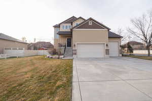 View of front of property with driveway, stucco siding, an attached garage, and board and batten siding
