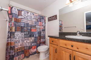 Bathroom featuring vanity, curtained shower, and light tile patterned floors
