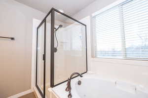 Bathroom with a tub with jets and a shower stall