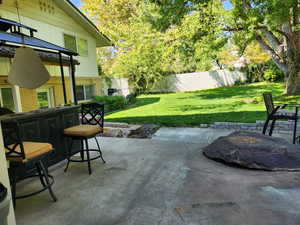 Fenced backyard with a patio area
