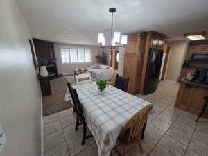 Kitchen eating featuring a chandelier, light tile patterned floors.