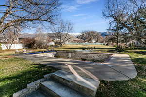 View of property's community featuring a mountain view, a patio area, and a residential view