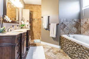 Primary Full bathroom featuring a garden tub, shower, toilet room and vanity with tile floors