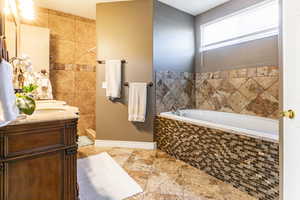 Primary Full bathroom featuring a garden tub, shower, toilet room and vanity with tile floors
