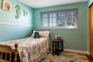 Level 1 1/2 - Bedroom with planation shutters and wood floors