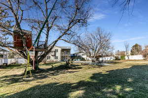 View of yard featuring mature trees and  residential view
