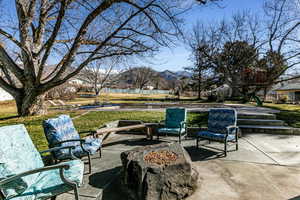 View of patio featuring a mountain view and a fire pit