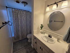 Level 1 1/2 - Full bathroom with vanity and shower / tub combo with curtain