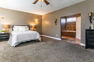 Bedroom featuring carpet floors, ensuite bath, and ceiling fan