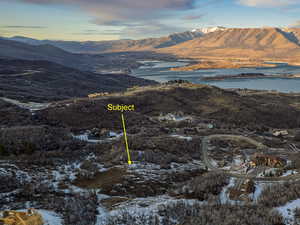 Aerial view of property and surrounding area with a water and mountain view