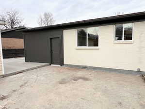 Property entrance with a patio area and brick siding