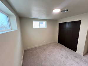 Unfurnished bedroom with a closet and carpet