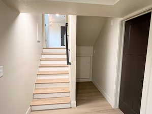 Stairway featuring wood finished floors and baseboards
