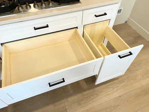 Detailed view of white cabinets and stainless steel gas cooktop