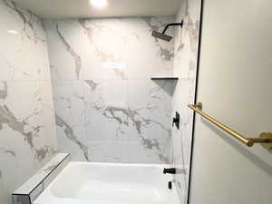 Bathroom with a combined bath / shower with marble appearance