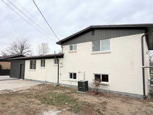 View of side of property with brick siding and a cooling unit