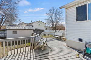 Deck featuring a fenced backyard and a storage shed