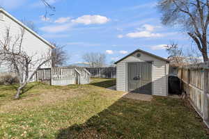 View of shed with a fenced backyard