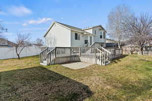 Back of property featuring a fenced backyard, a deck, and stairway