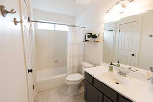 Full bath featuring shower / bath combo with shower curtain and vanity