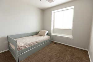 Carpeted bedroom featuring baseboards