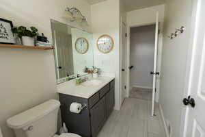 Full bath featuring vanity and toilet