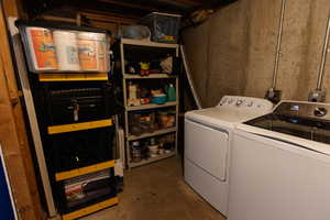 Laundry room with concrete flooring and washer and clothes dryer