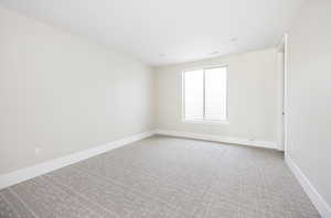 Unfurnished room featuring light colored carpet and baseboards