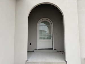 View of exterior entry featuring stucco siding