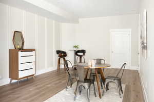 Dining space with wood finished floors and recessed lighting
