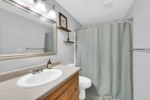 Bathroom featuring vanity and a shower with shower curtain