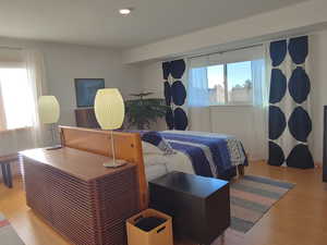 Large bedroom featuring multiple windows with fabulous  views, and lots of natural light, bamboo flooring