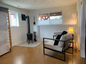 Family room sitting area with cork flooring, wood burning stove, daylight windows.