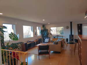 Living room featuring a wood stove,  beautiful views,  Cork & bamboo flooring, lovely natural light