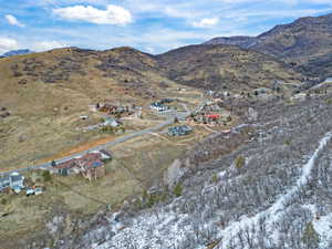 Aerial view of property and surrounding area with a mountainous background