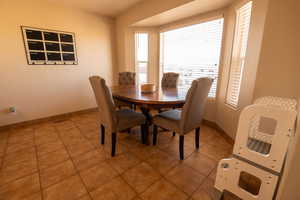 Dining room with light tile patterned floors and baseboards