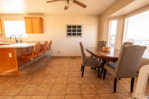 Dining room with ceiling fan and light tile patterned floors